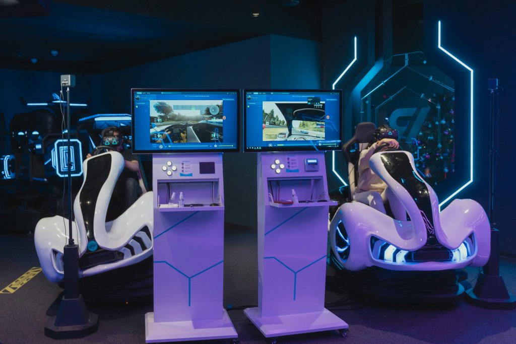 Futuristic gaming chairs with VR headsets and monitors, capturing immersive gameplay in a modern arcade.